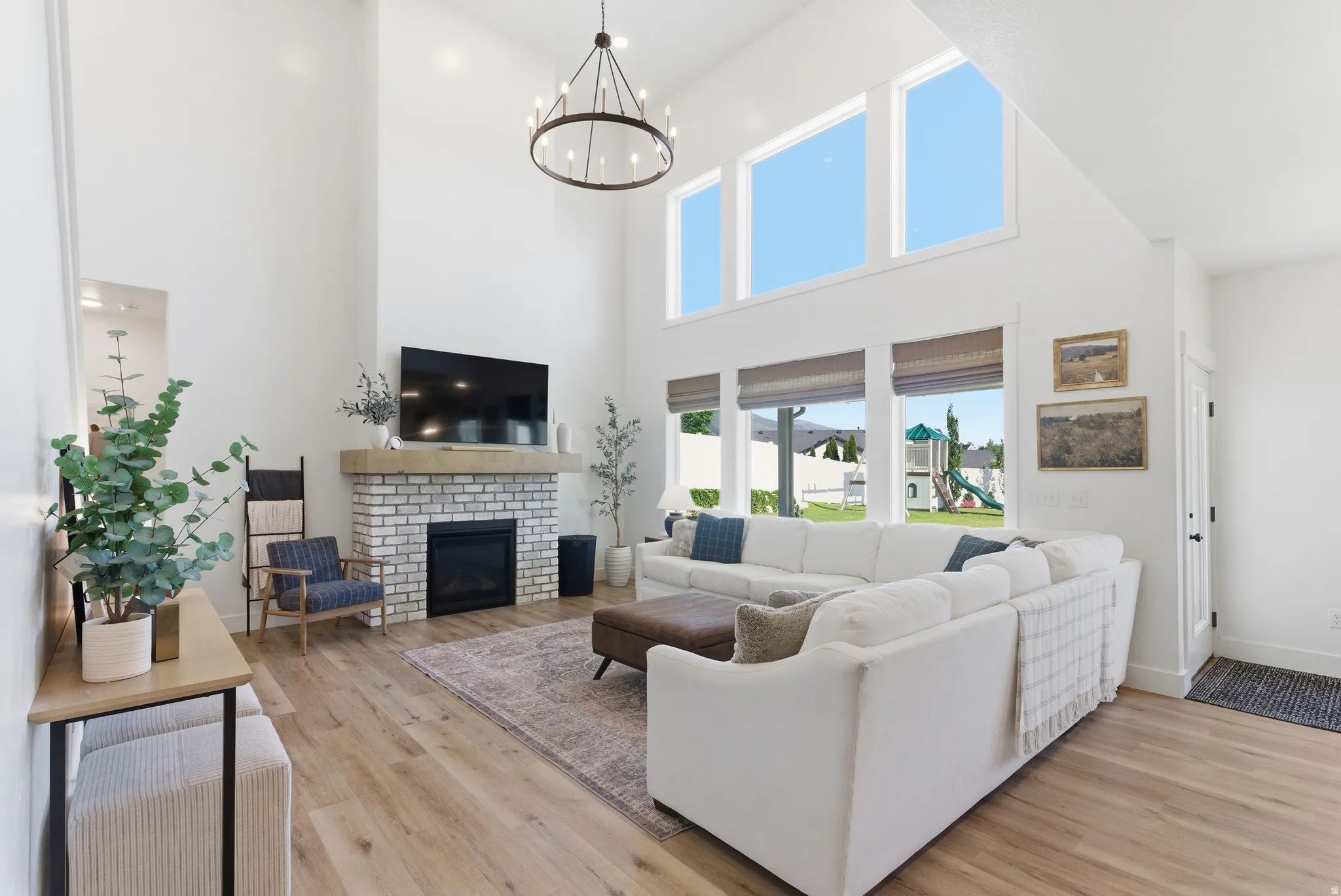 Vaulted ceiling great room with wood-finish flooring