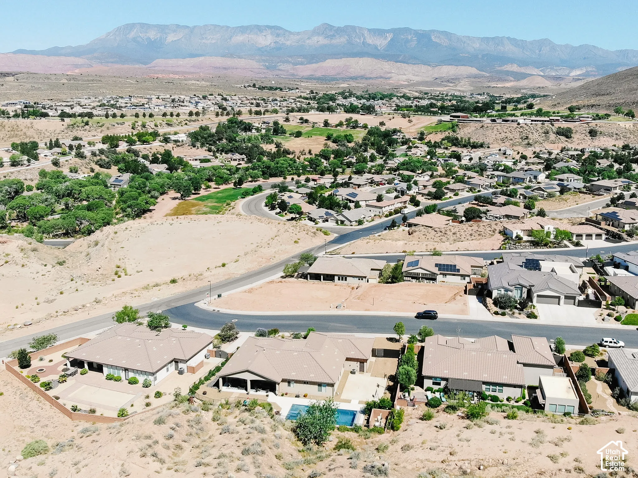 Aerial perspective showcasing a residential community with distant mountain ranges