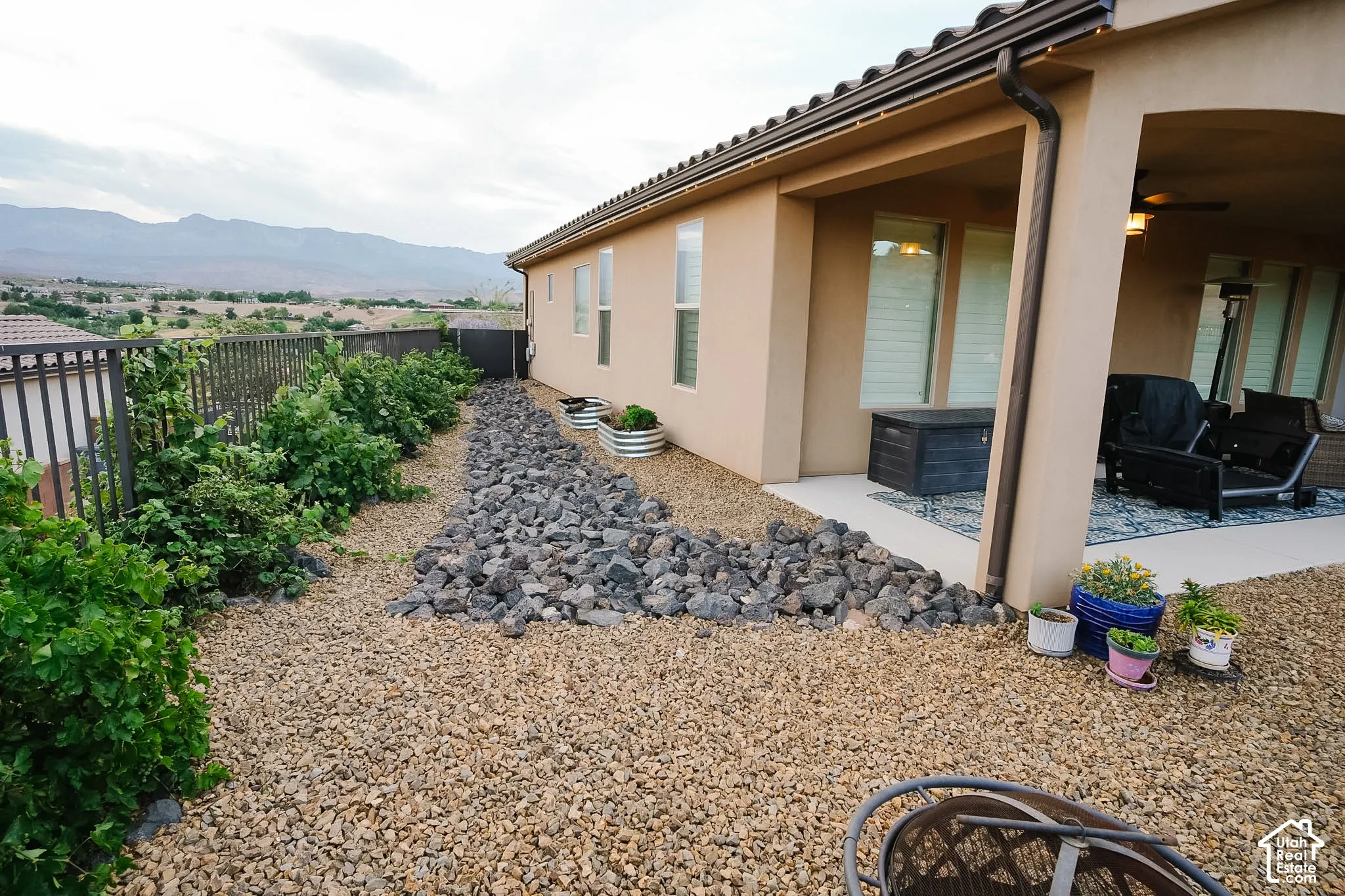 Xeriscape landscaping featuring decorative rock and mature shrubbery