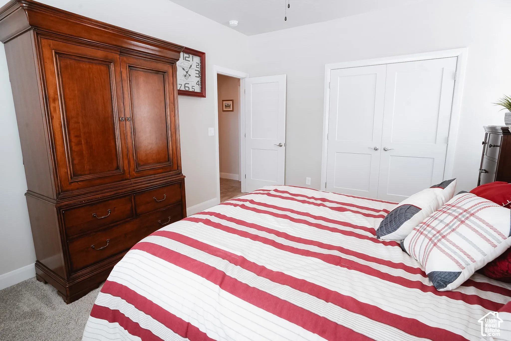 Neutral wall paint, plush carpet flooring, and white double-panel doors