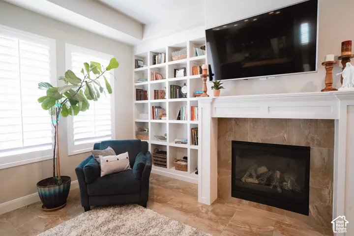 Built-in fireplace with a tiled surround, white mantel, and integrated television mount