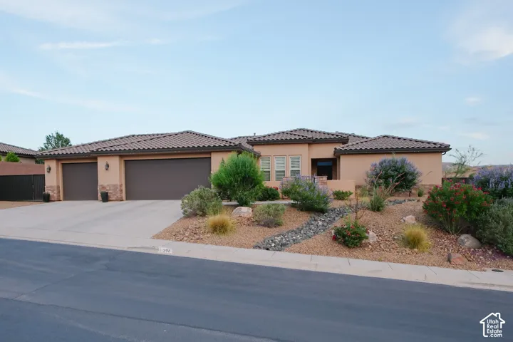 Stucco exterior with stone accents and a tile roof