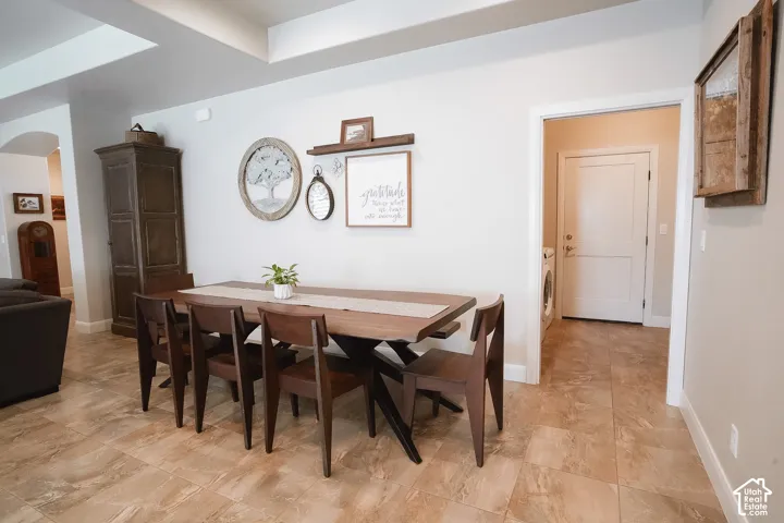 Spacious dining area featuring neutral wall tones and coffered ceilings