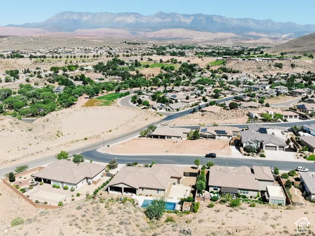 Aerial perspective showcasing a residential community with distant mountain ranges
