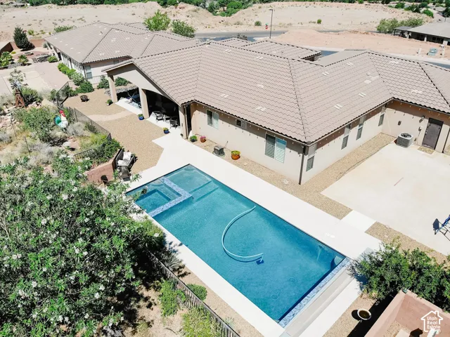 Rectangular in-ground pool featuring an integrated spa