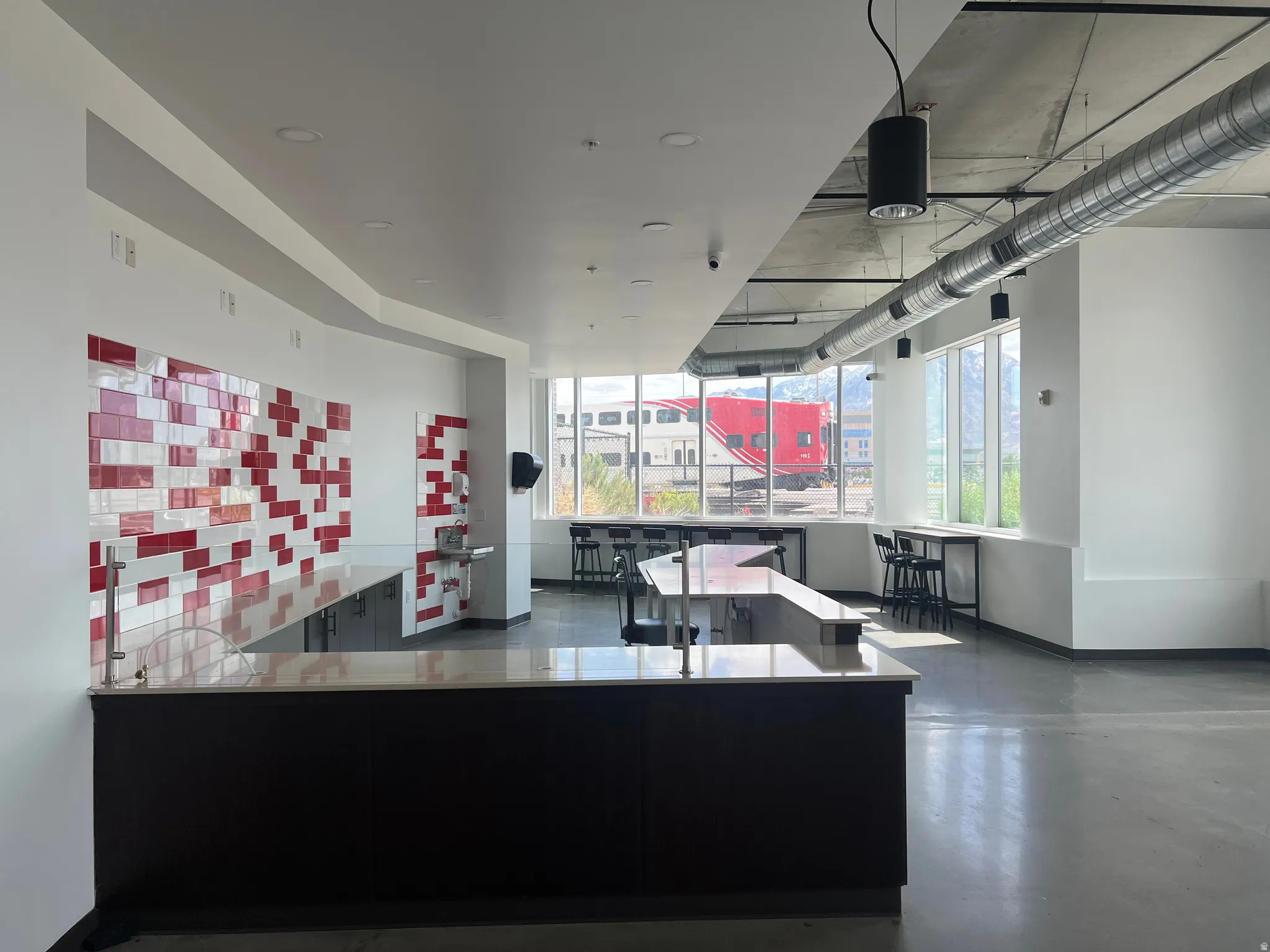 Spacious interior featuring a large serving counter with a light-toned surface