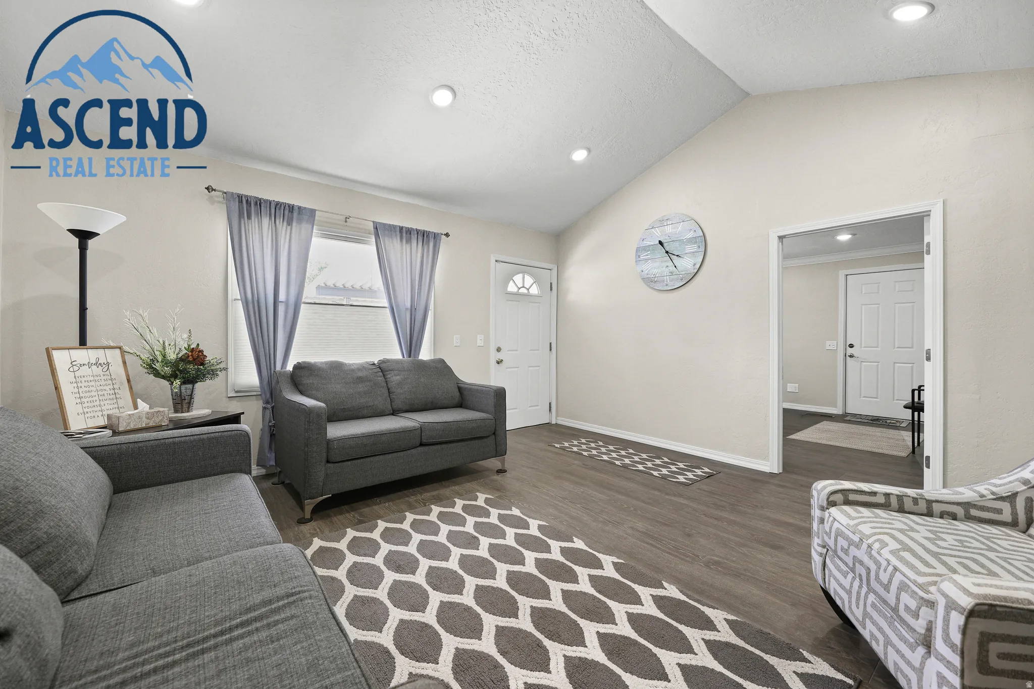 Spacious waiting/office area featuring wood-finish flooring, vaulted ceilings, recessed lighting.