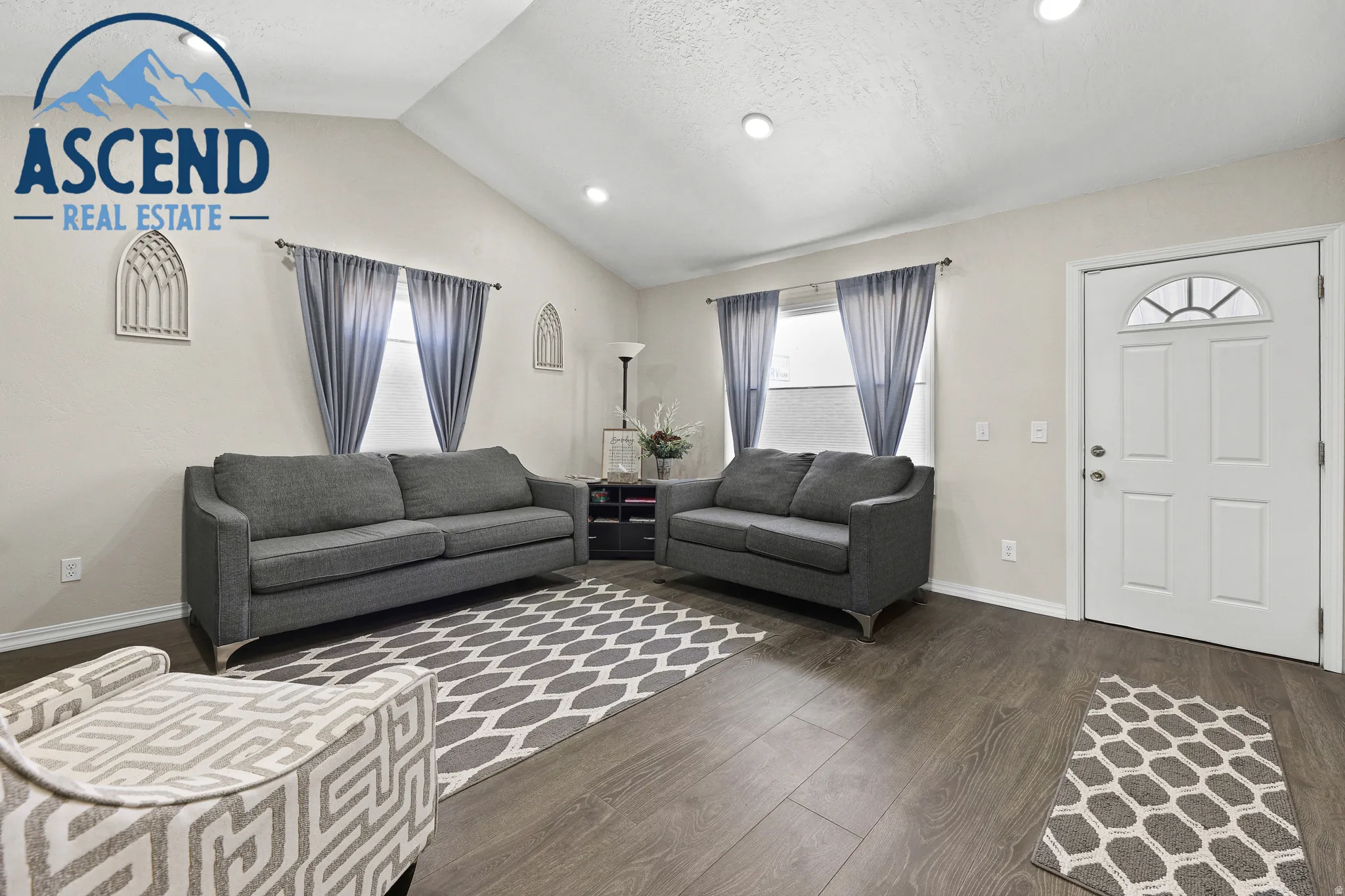 Vaulted ceiling waiting/office space with recessed lighting, wood-finish flooring, and white trim