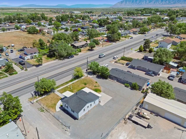 Aerial perspective showcasing the property with a white exterior and dark roof