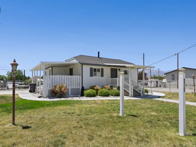 Single-story featuring a covered front porch and white lattice accents
