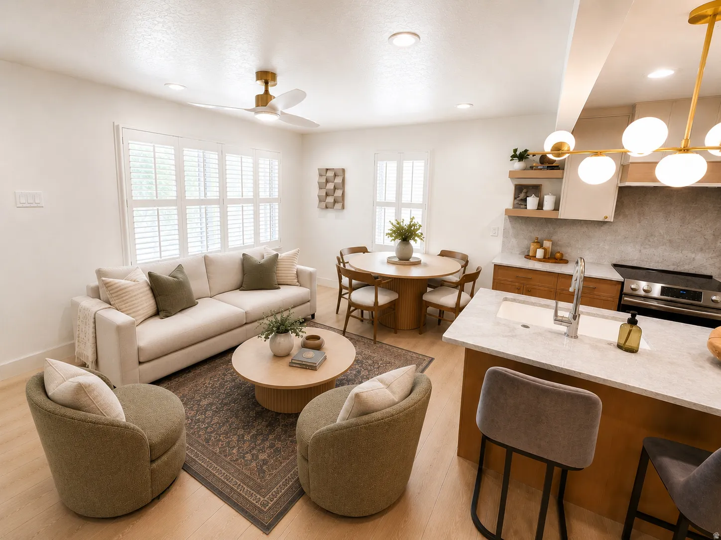 Open-concept living space featuring light wood-finish flooring, recessed lighting, and a modern gold-finish ceiling fan
