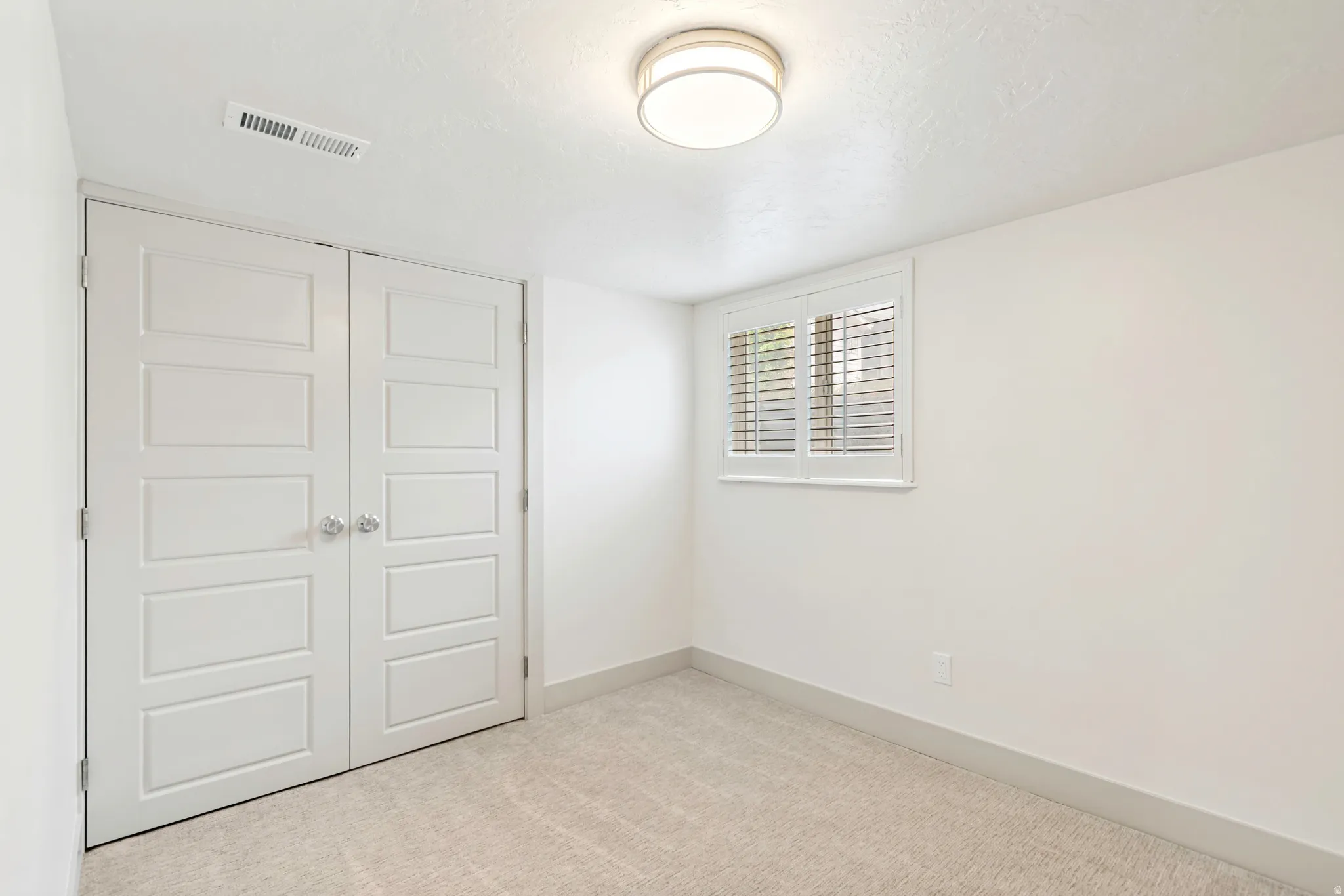 Neutral-toned carpeting paired with white walls