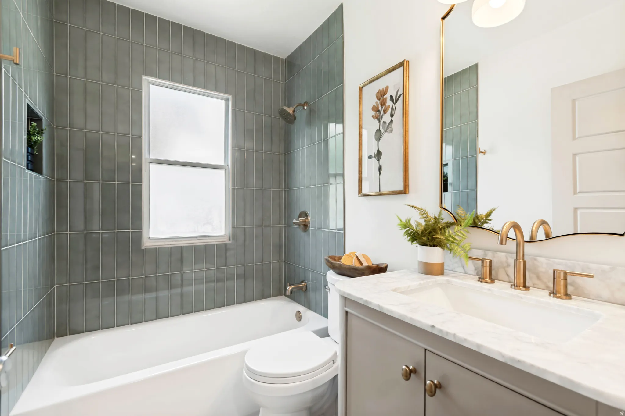 Bathroom featuring a full tub with subway tile surround, integrated shower niche, and a window with privacy glass