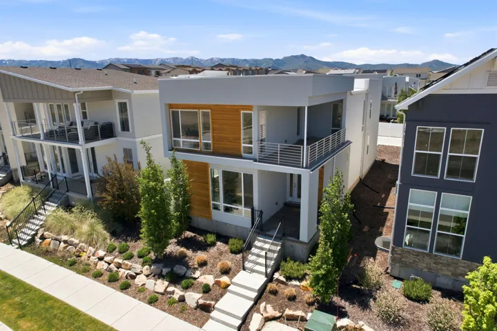 Modern architectural facade featuring light gray and wood-tone paneling