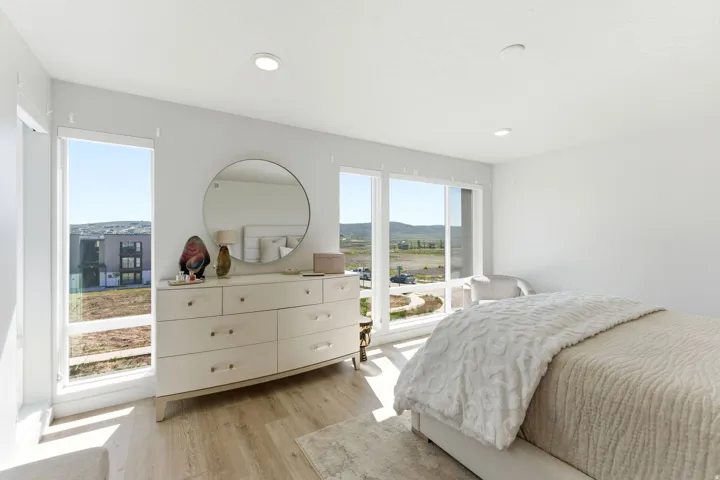Spacious room with large windows, recessed lighting, and light wood-finish flooring