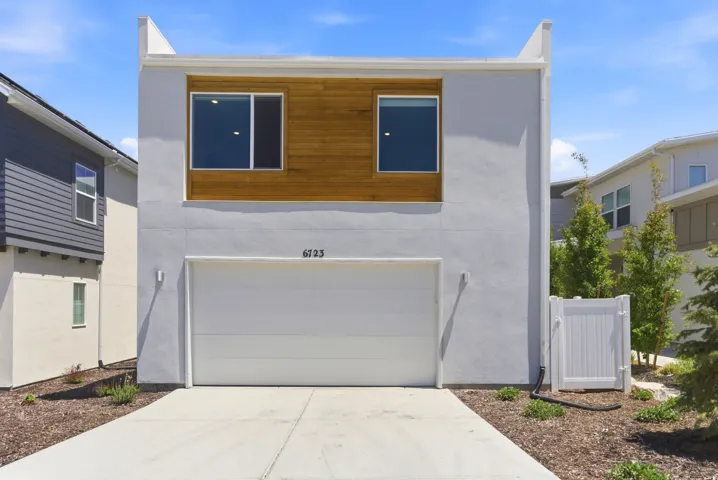 Modern stucco exterior with wood paneling accents