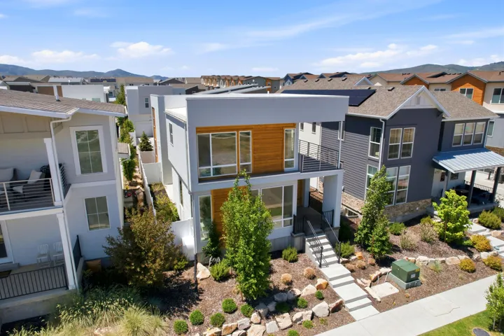 Contemporary multi-story residence featuring a flat roofline and integrated wood-finish paneling