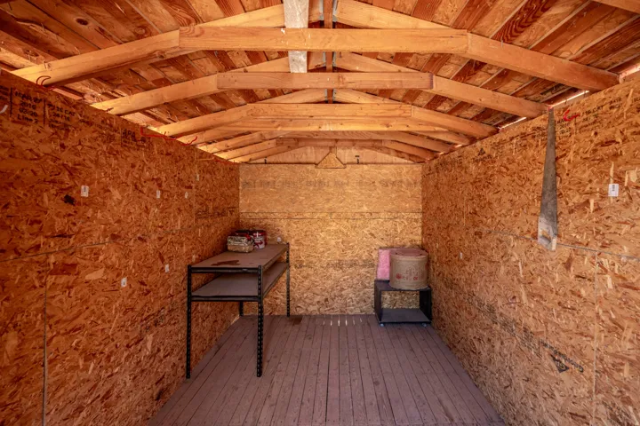 Interior storage structure featuring exposed wood framing and OSB paneling