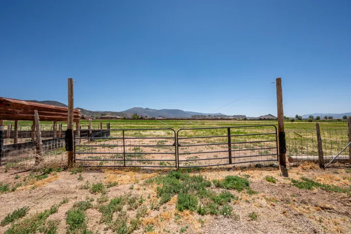 Expansive open field with a metal gate entrance