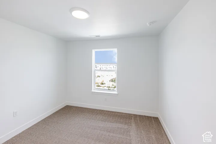 Recessed ceiling light fixture and window with white trim