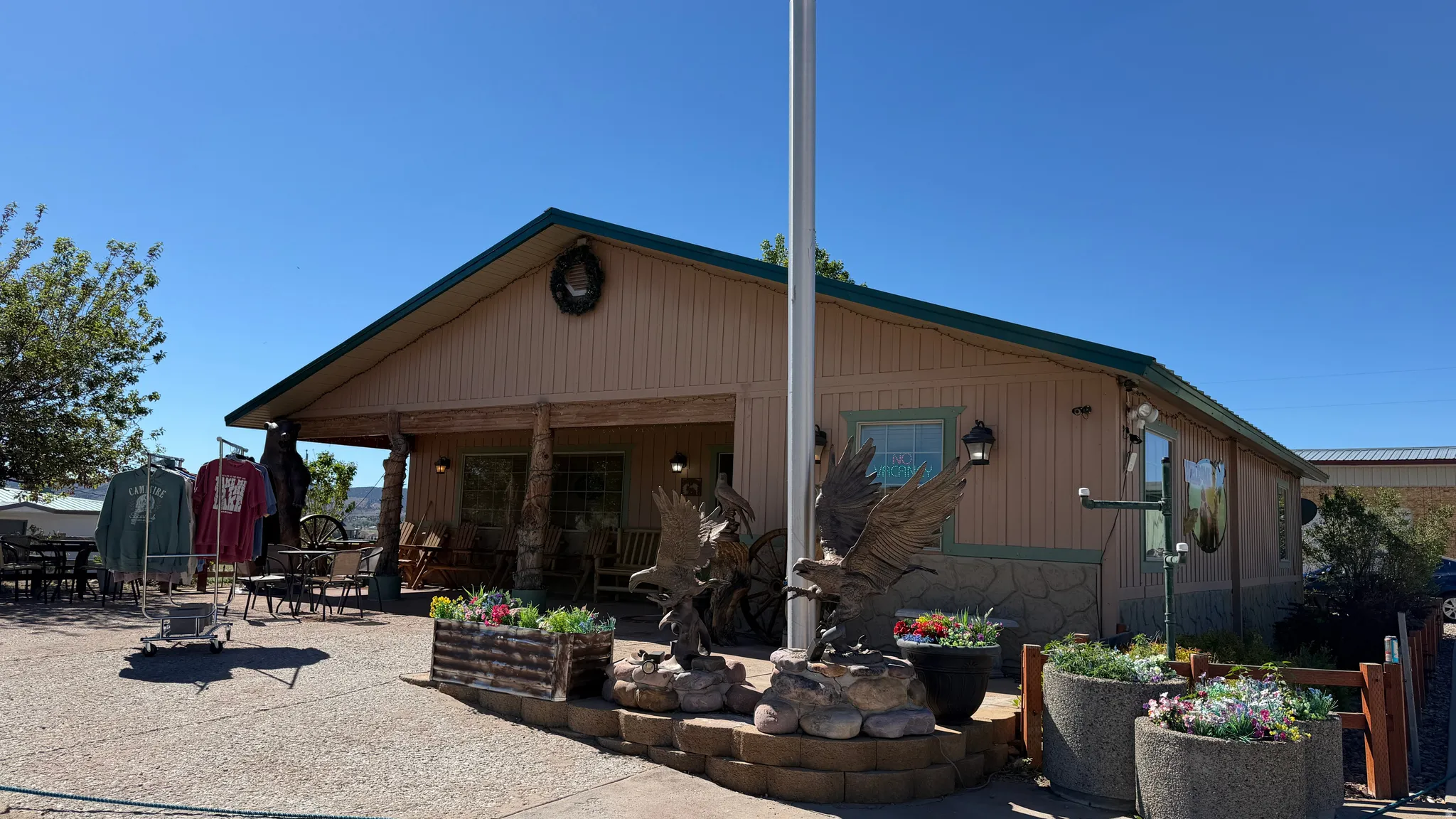 Single-story structure with a covered front porch, wood-look siding, and a stone veneer base