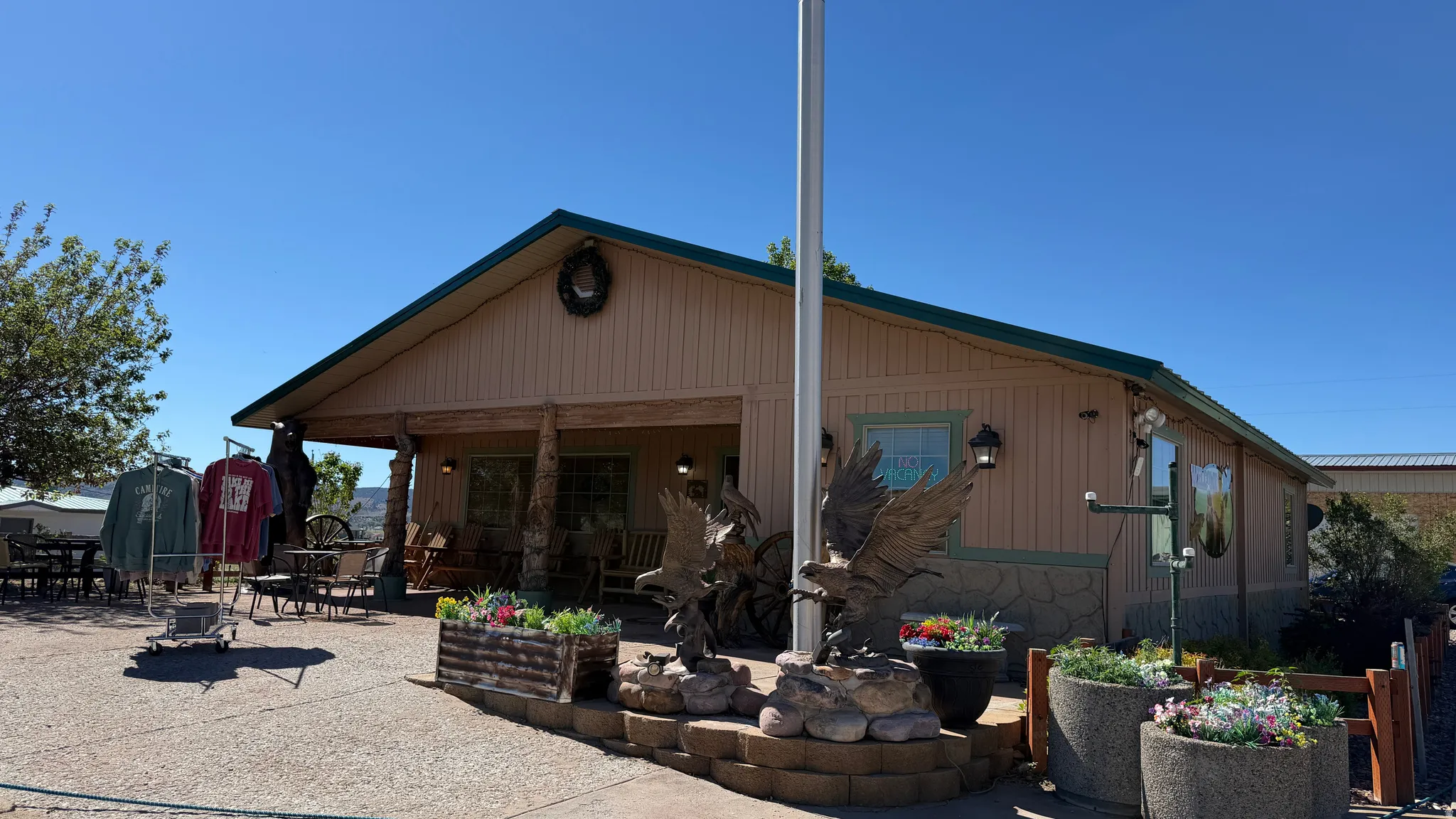 Front facade with a covered porch, stone accent siding, and horizontal paneling