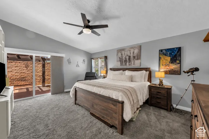 Spacious room featuring newer carpet, 3-tone paint, a vaulted ceiling, door to patio, with window covering.