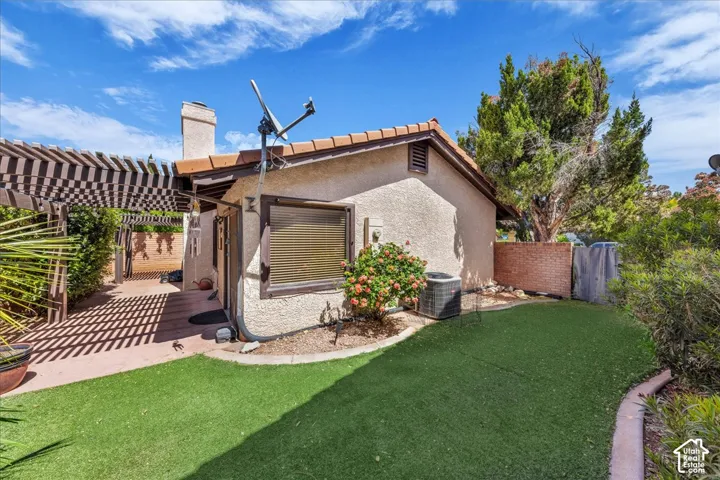 Private, fully fenced rear yard with turf, patio, and dual pergolas