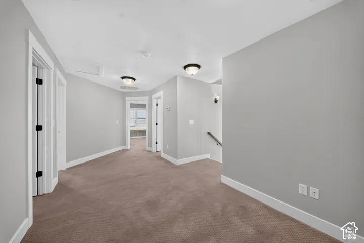 Neutral-toned carpeting, light gray wall paint, white trim, and recessed lighting fixtures