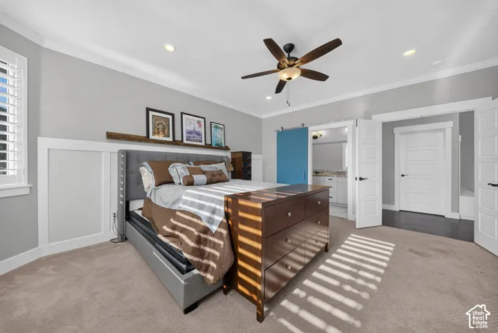 Spacious primary bedroom featuring neutral wall finishes, recessed ceiling lighting, and a ceiling fan with brushed metal accents