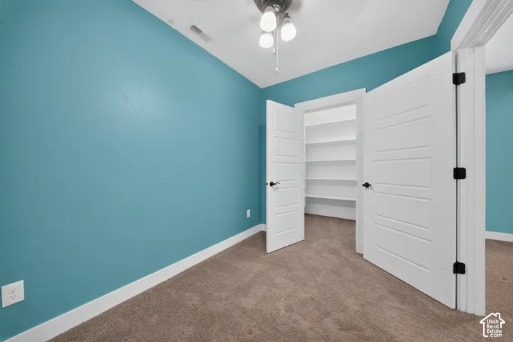 Bright turquoise walls with crisp white trim and ceiling create a refreshing backdrop in this versatile room
