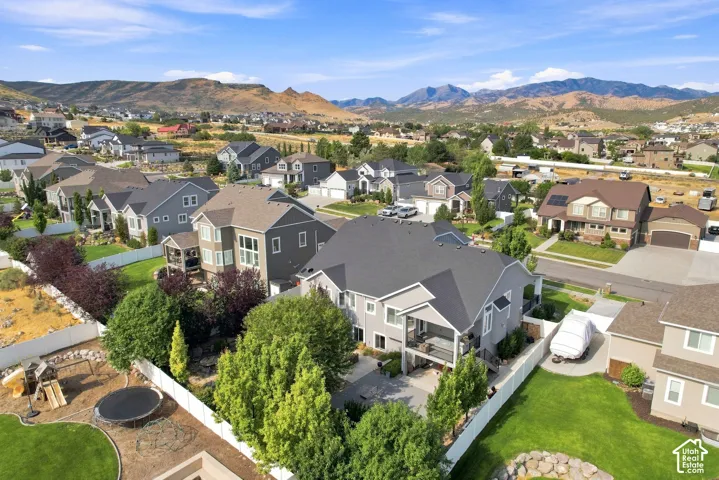 Elegant two-story home featuring a charcoal composite roof, light-colored siding with architectural detailing