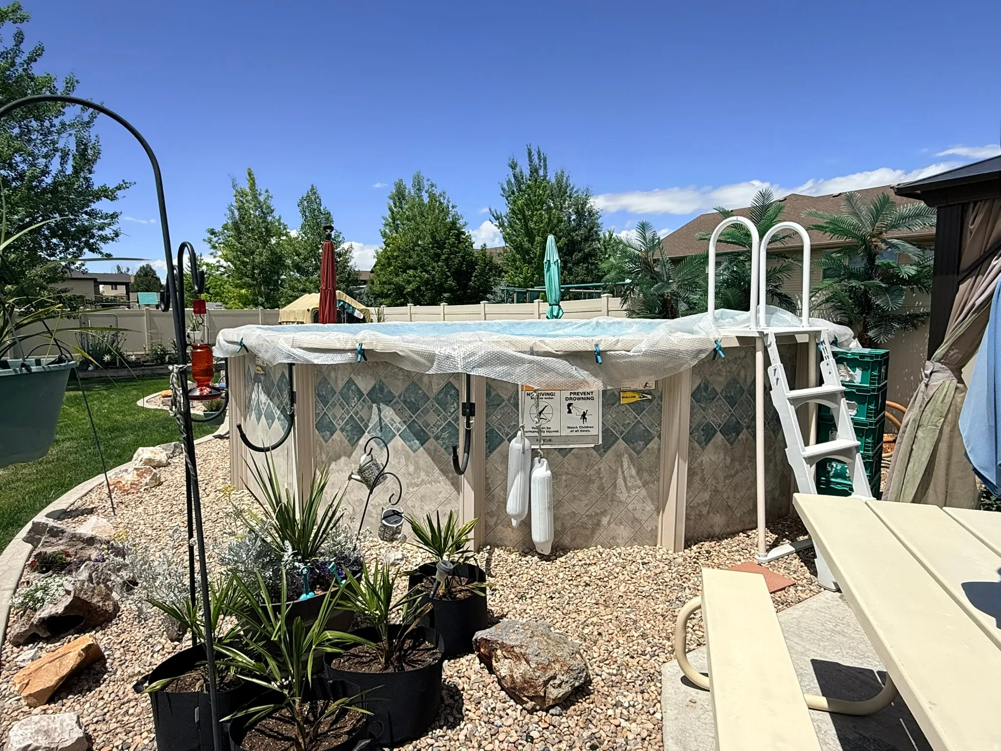 Above-ground pool with decorative paneling and a ladder for access