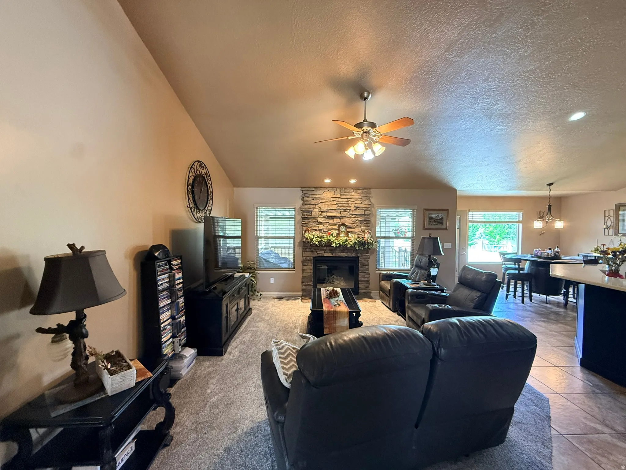 Living area featuring a stone-clad fireplace and hearth