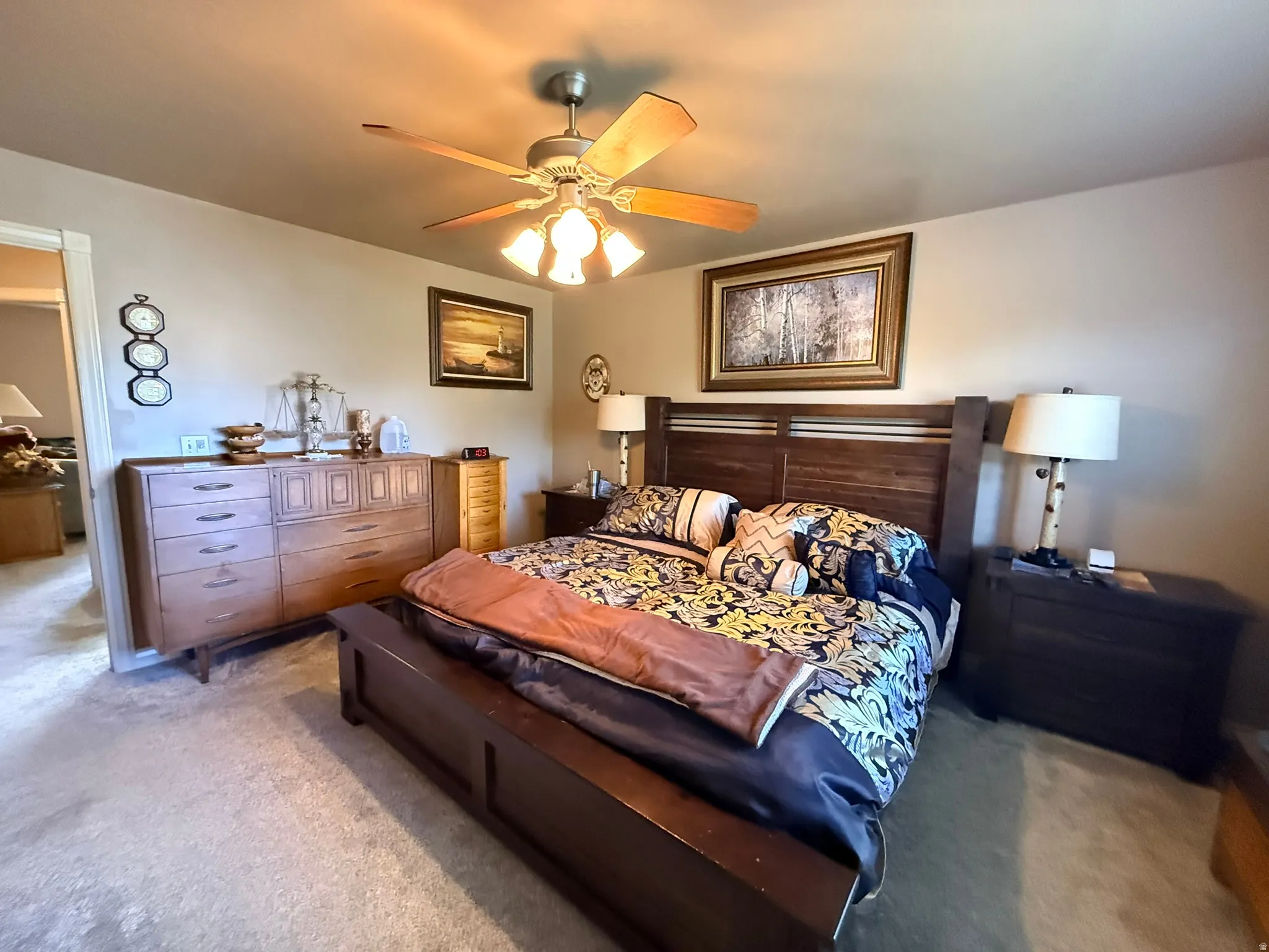 Spacious bedroom featuring light-colored wall paint and carpet flooring