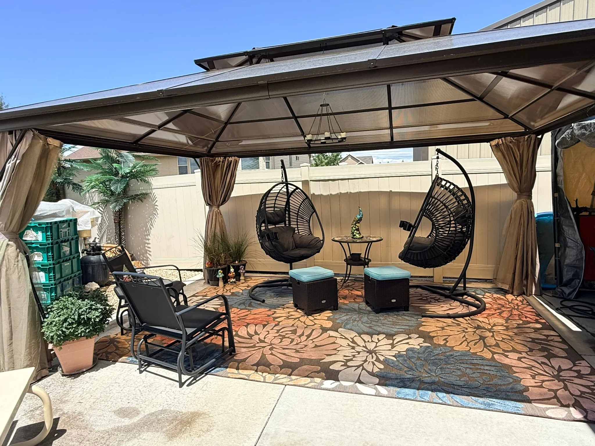 Outdoor patio featuring a permanent gazebo structure with a hardtop roof and integrated lighting