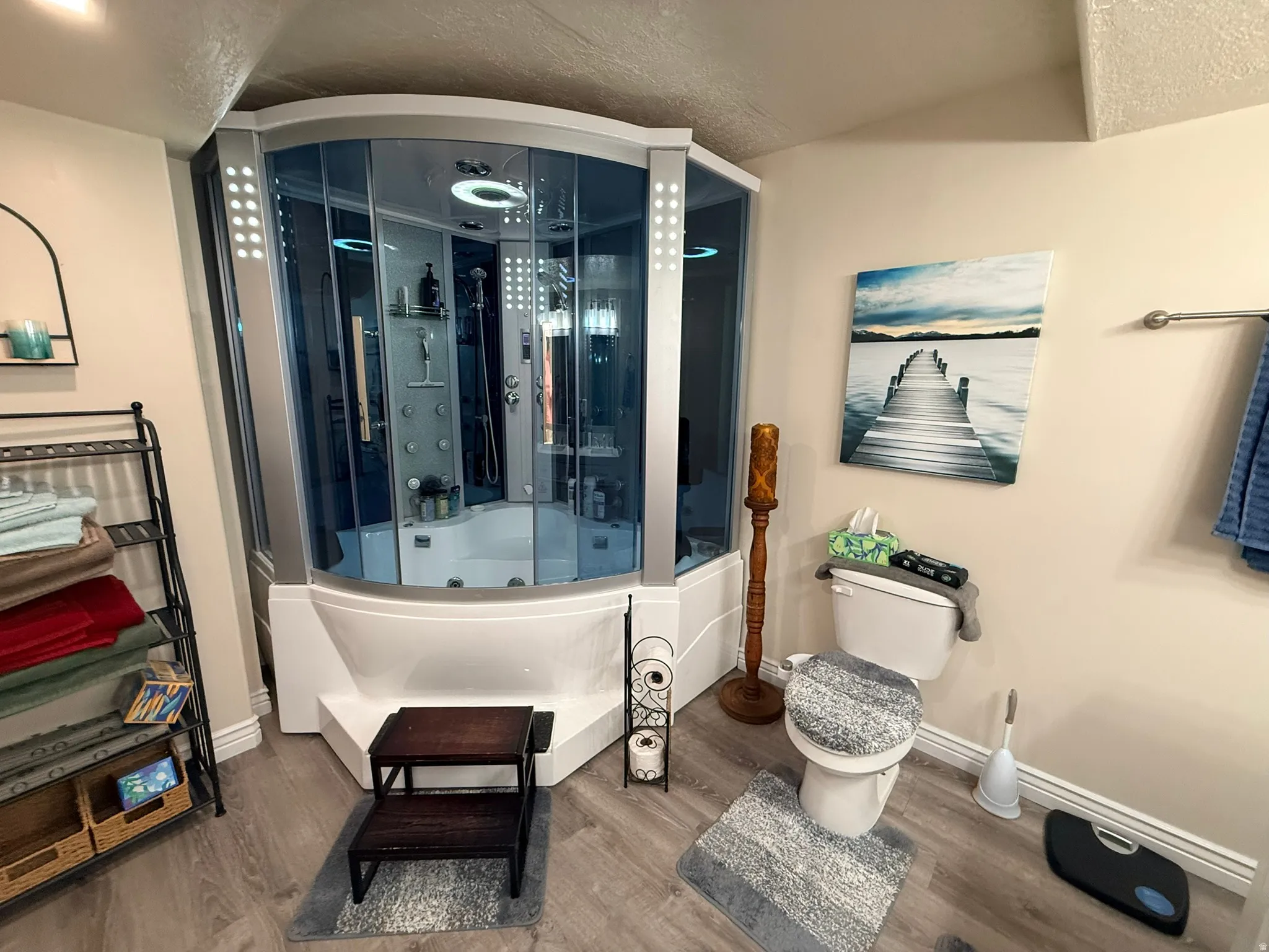 Corner steam shower enclosure with integrated tub and multiple shower jets