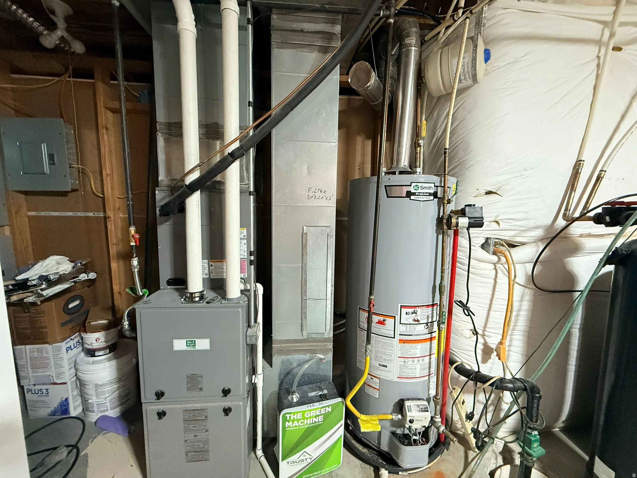 Mechanical systems featuring a forced-air furnace, hot water heater, exposed ductwork, and electrical panel