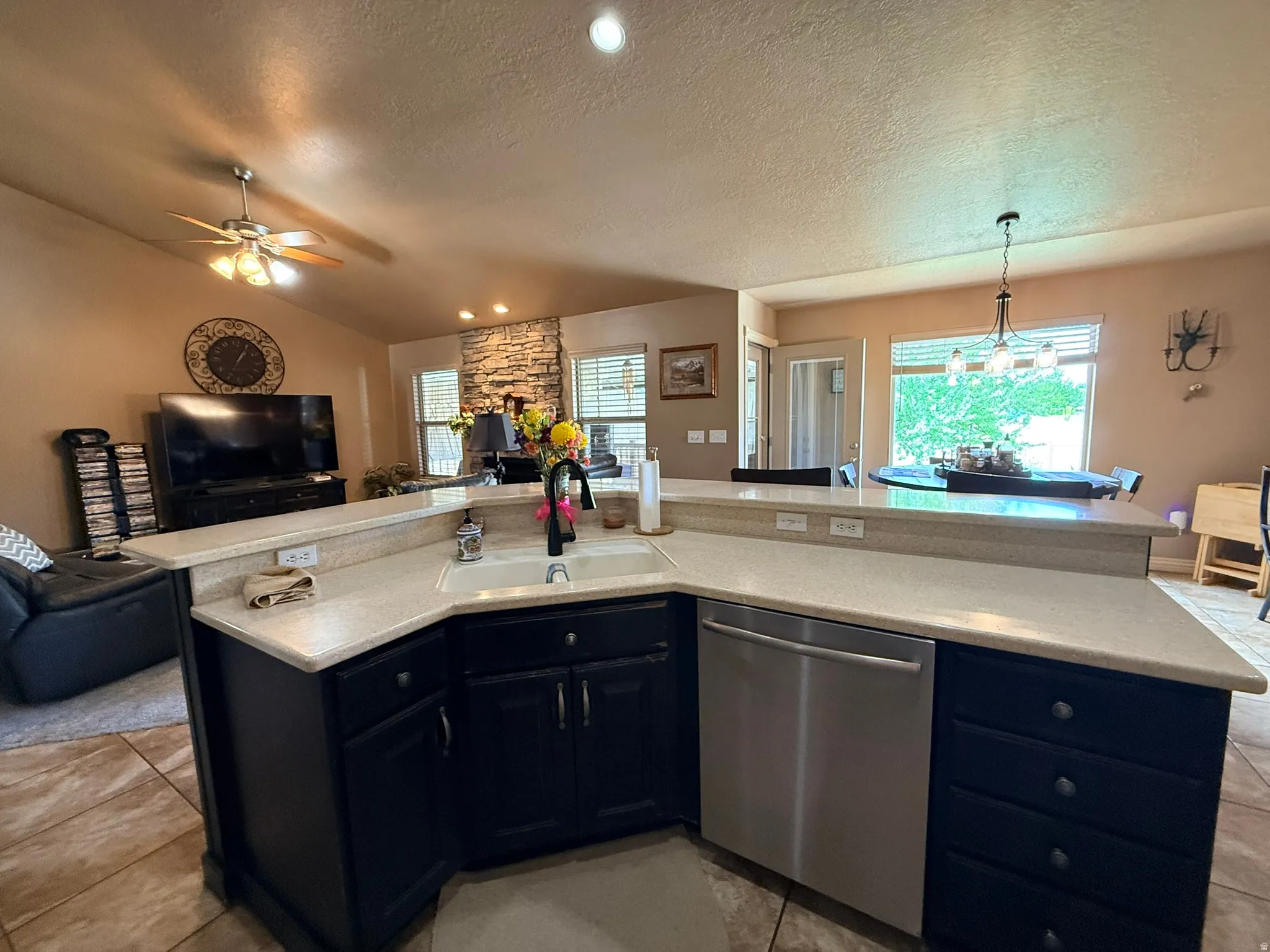 Expansive kitchen island featuring light-toned countertops and dark cabinetry