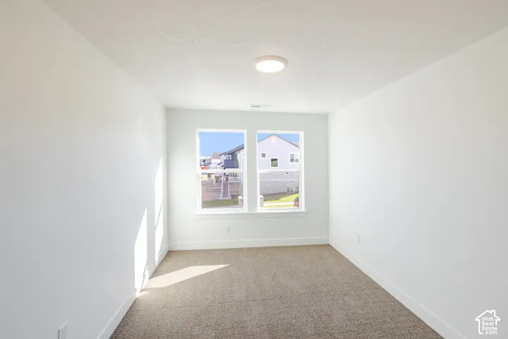 Dual windows, recessed lighting, white walls, and carpet flooring