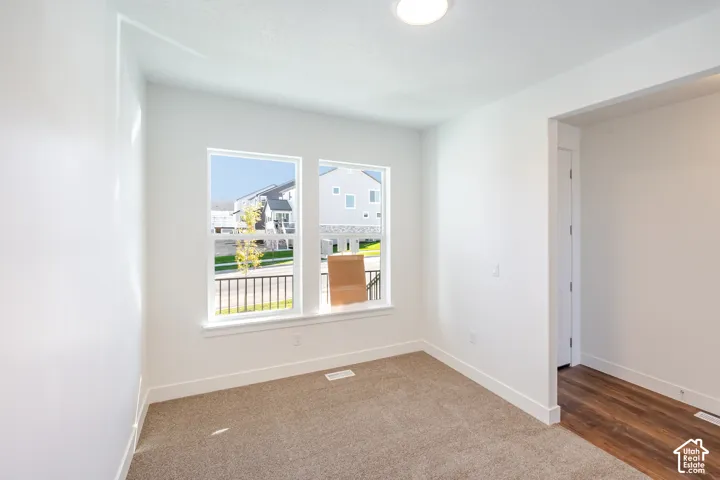 Wall-to-wall carpeting, dual windows, recessed lighting, and wood-finish flooring