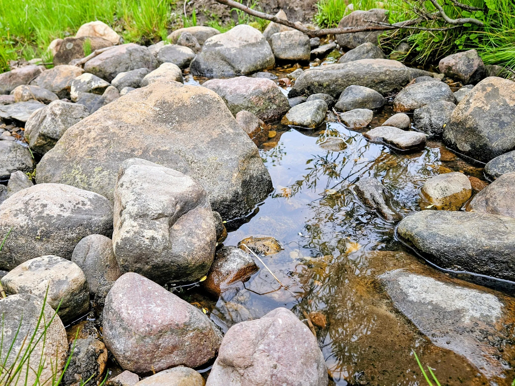 Natural rock-lined creek bed featuring clear water