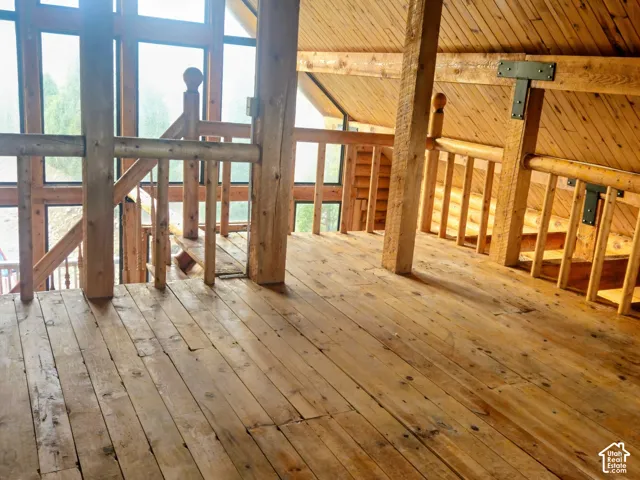 Wood-finish flooring with exposed wood beams and wood-paneled ceilings