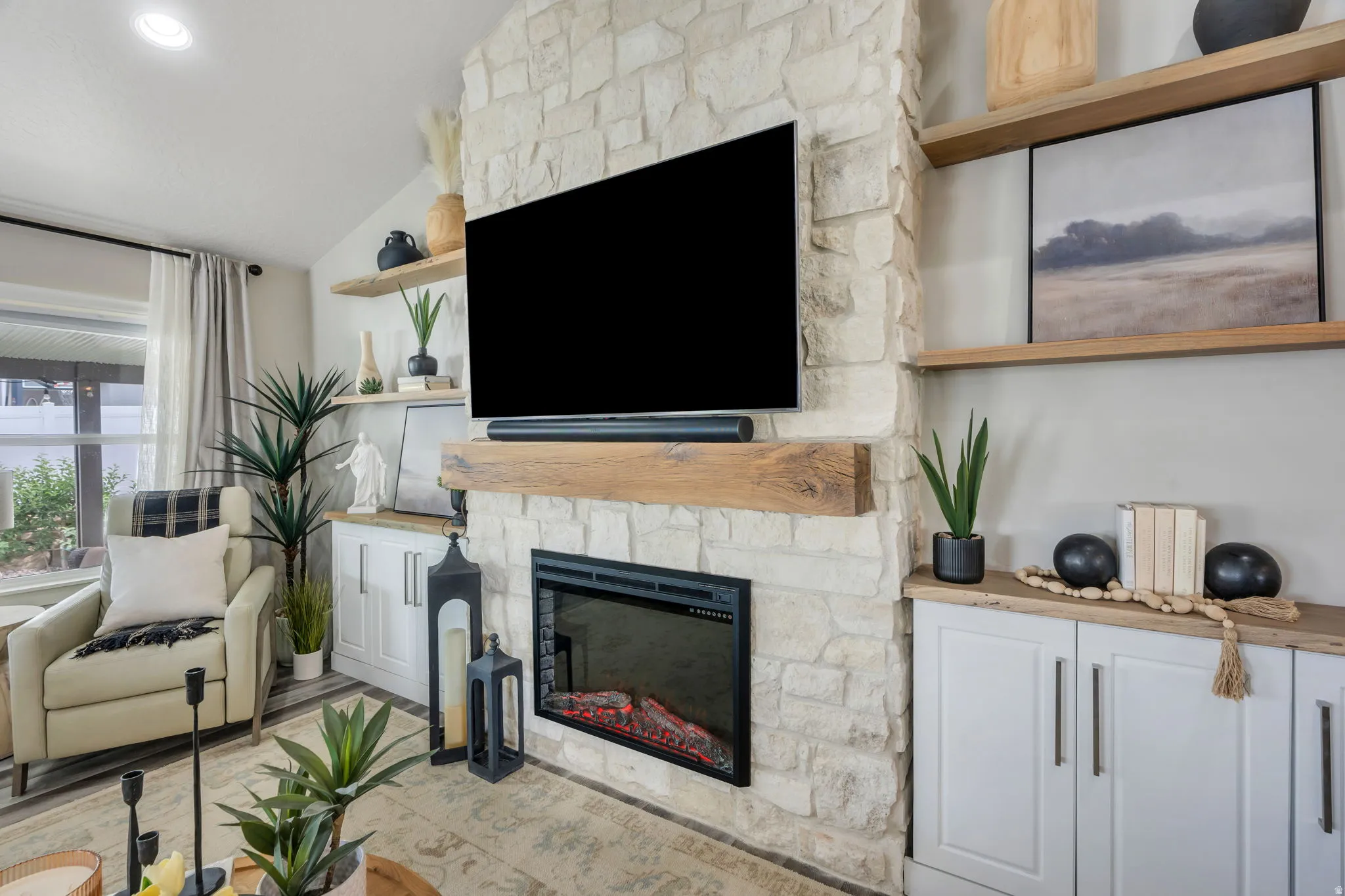 Austin stone fireplace, and solid white oak floating shelves