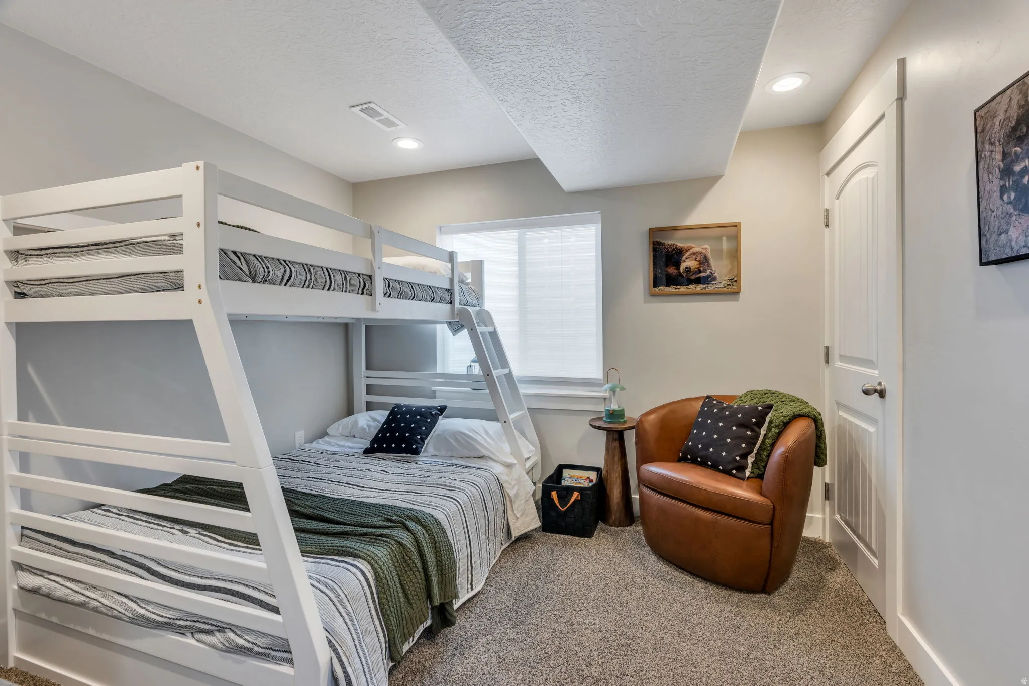 Carpeted bedroom featuring a bunk bed, recessed lighting, a window with blinds, and an interior door with an arched panel design
