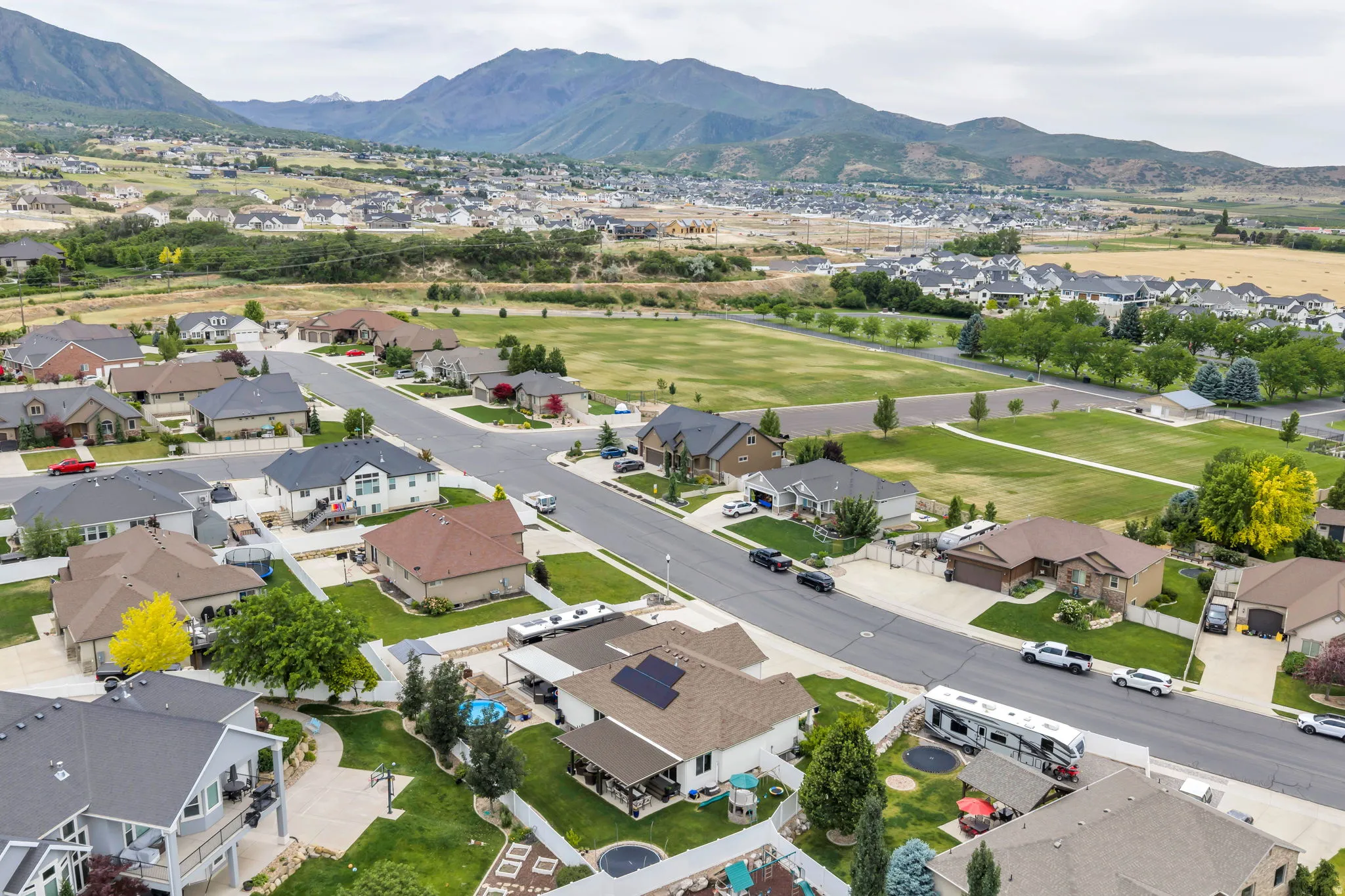 Expansive residential neighborhood with mature landscaping and mountain backdrops