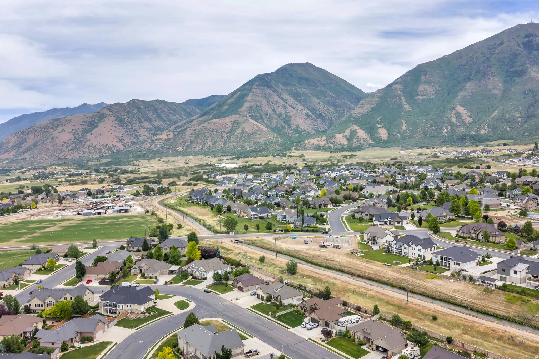 Expansive residential development nestled against a prominent mountain range