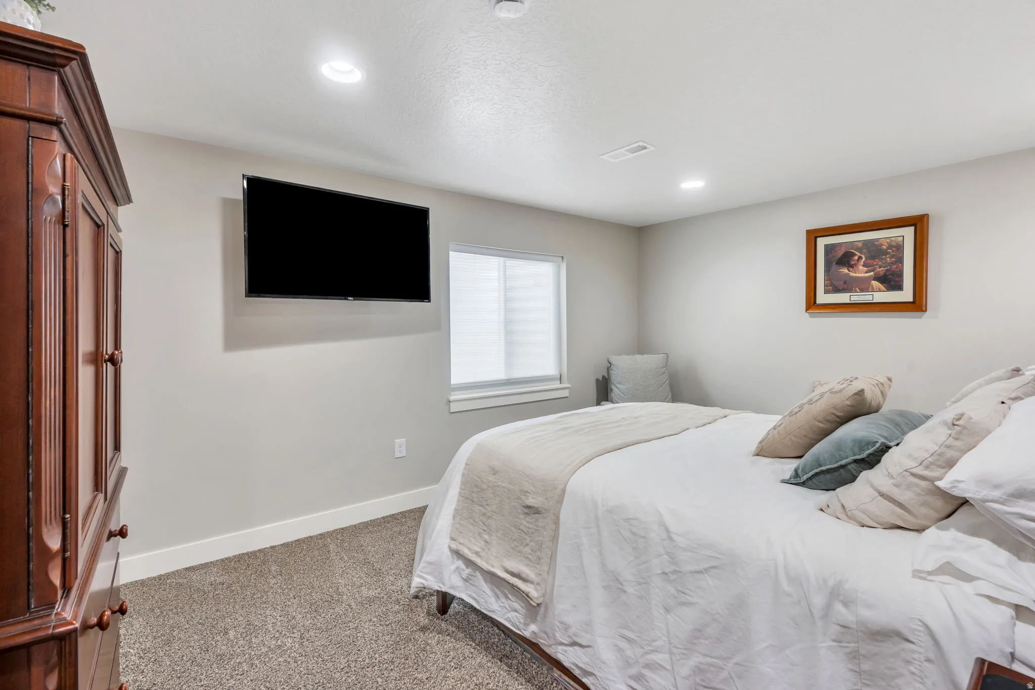 Bedroom featuring light gray walls, recessed lighting, and neutral-toned carpeting