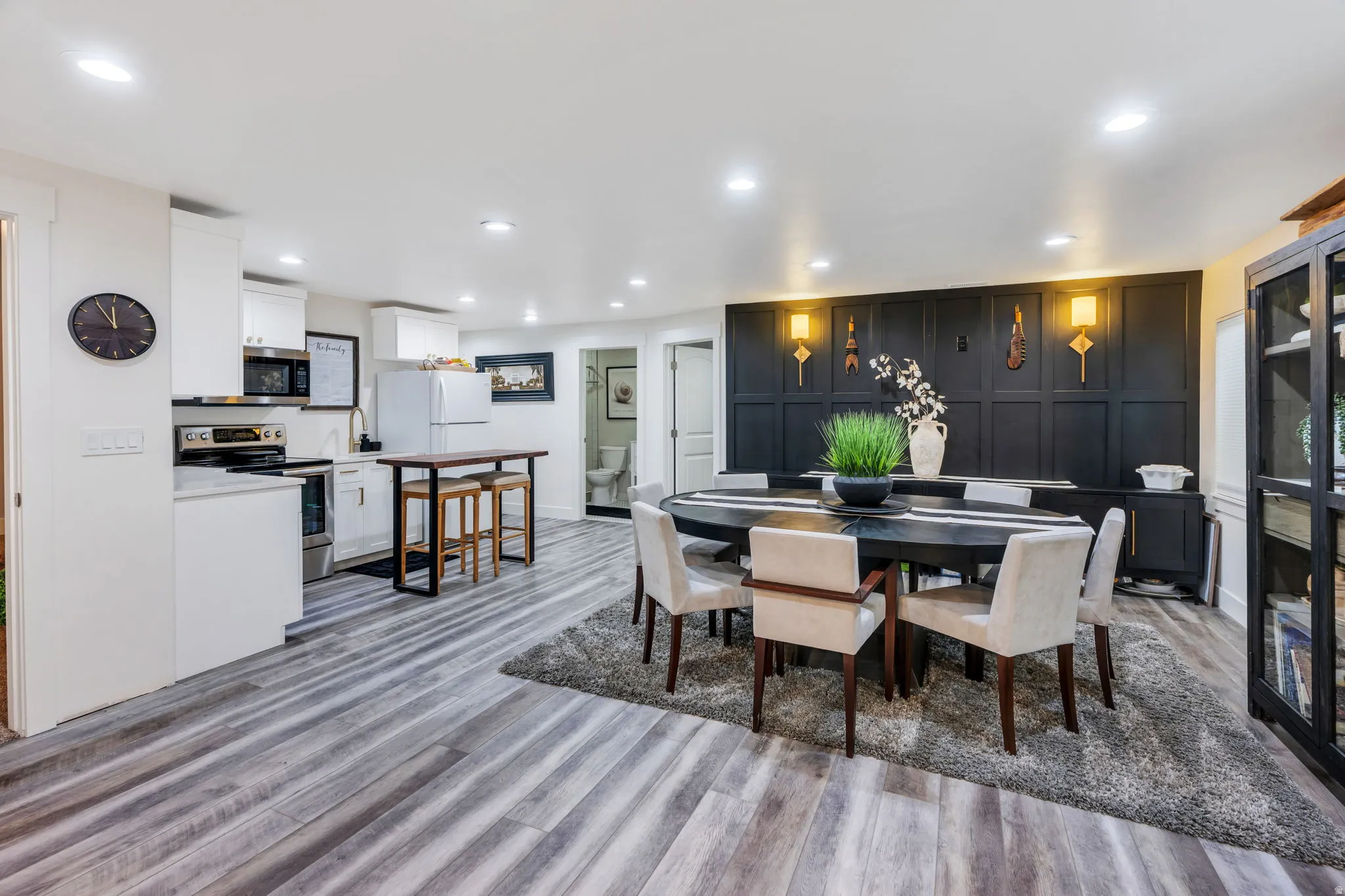 Basement game room - open-concept living space with wood-finish flooring