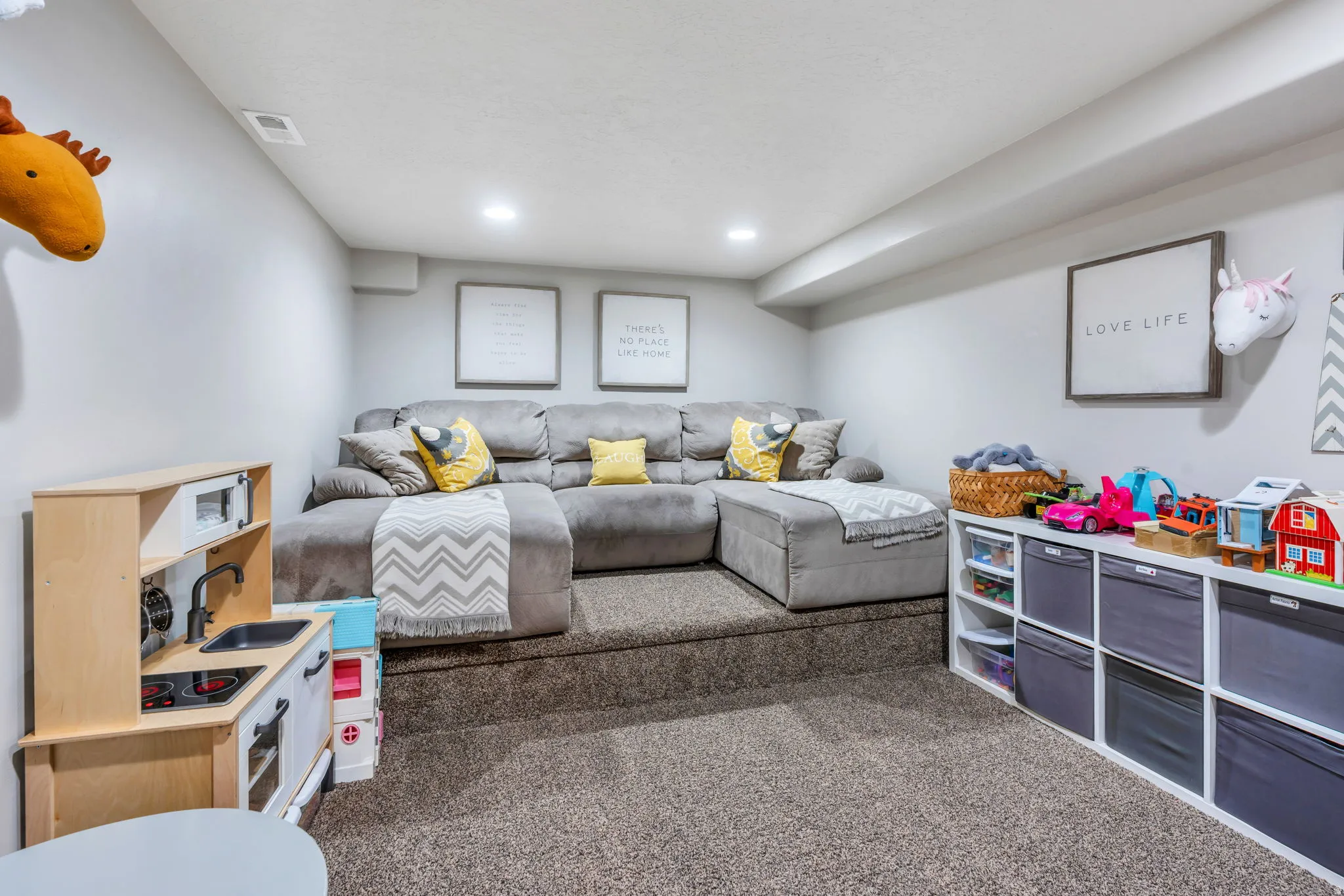 Second theater room with multi-level sitting featuring recessed lighting, white wall.